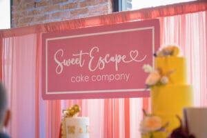 A Pink color Pamplet with the prompt of "Sweet Escape Cake Company "