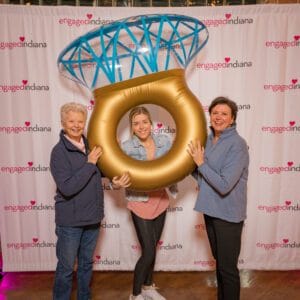 3 women posing with the ring shape ballons